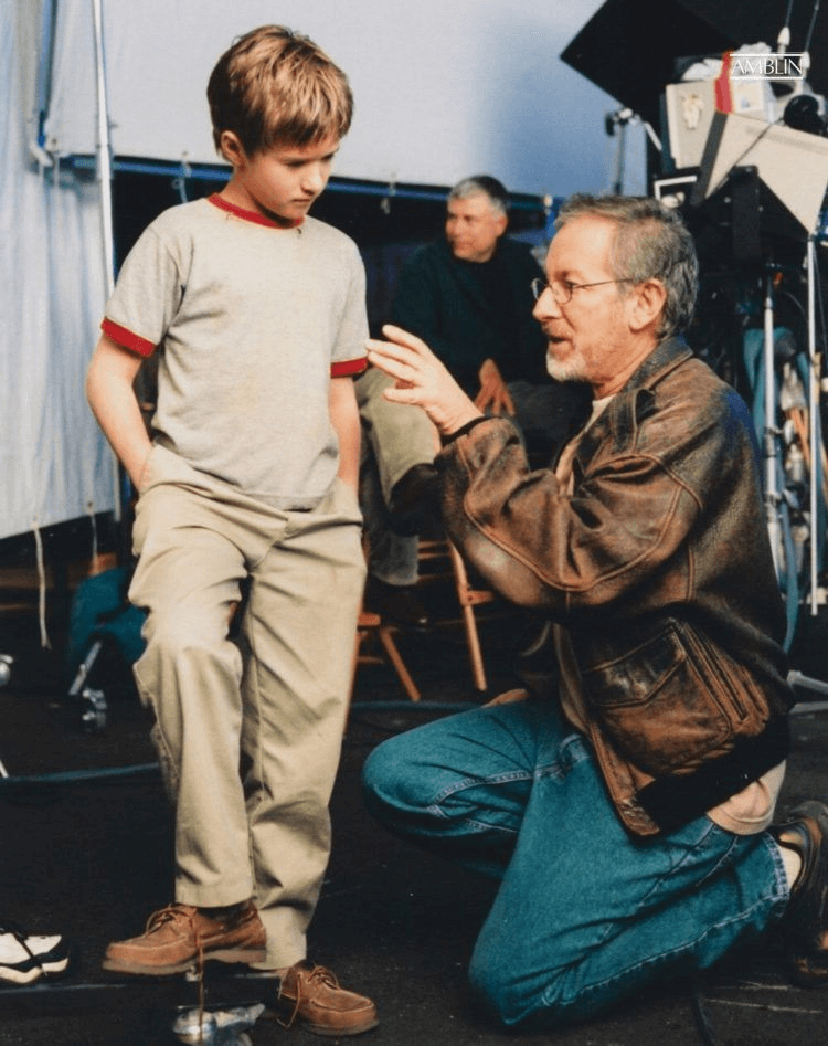 A young Haley Joel Osment, who plays the robot boy David, listens intently to his director’s ideas in production on A.I. Artificial Intelligence.