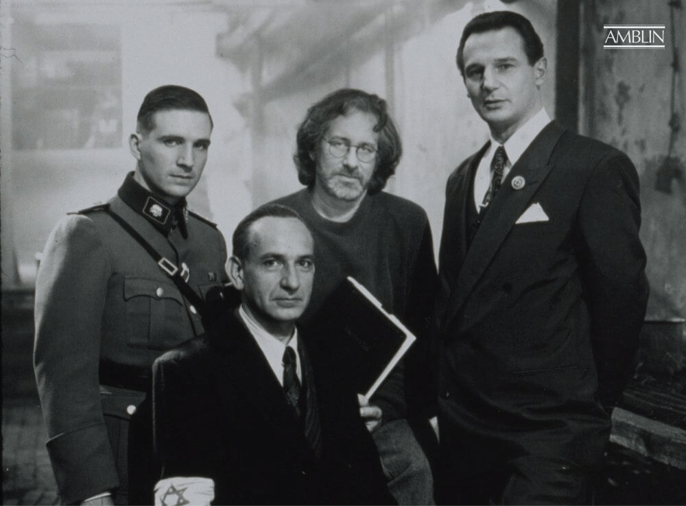 Posing with his trio of actors at the heart of the struggle in Schindler’s List, (L to R) Ralph Fiennes, Sir Ben Kingsley, Spielberg and Liam Neeson. Spielberg holds a bound edition of the screenplay in hand.